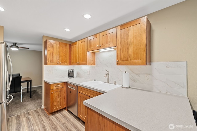 4714 Fairwood Blvd NE Unit 1704, Tacoma, WA 98422 - kitchen featuring appliances with stainless steel finishes, light wood-style floors, decorative backsplash, light countertops, and recessed lighting