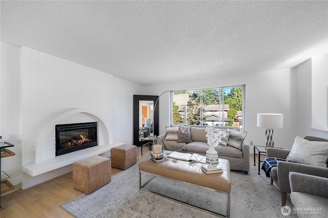 33513 35th Ave SW, Federal Way, WA 98023 - living area featuring a textured ceiling, wood finished floors, and a brick fireplace