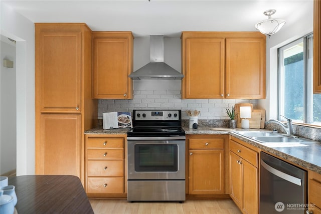 33513 35th Ave SW, Federal Way, WA 98023 - kitchen with appliances with stainless steel finishes, wall chimney range hood, decorative backsplash, and light wood finished floors