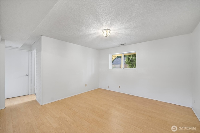 33513 35th Ave SW, Federal Way, WA 98023 - unfurnished room with light wood finished floors and a textured ceiling