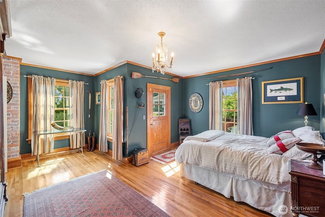 4410 N 45th St, Tacoma, WA 98407 - bedroom with a chandelier, a textured ceiling, wood finished floors, and crown molding