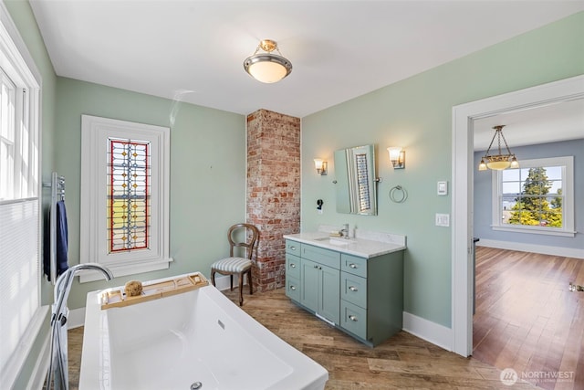 4410 N 45th St, Tacoma, WA 98407 - full bath with vanity, a freestanding tub, and wood finished floors