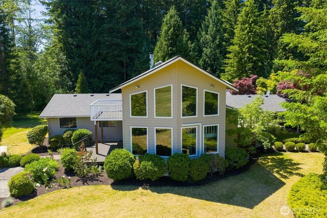 25321 133rd Ave NE, Arlington, WA 98223 - back of property with a lawn, a wooden deck, and a forest view