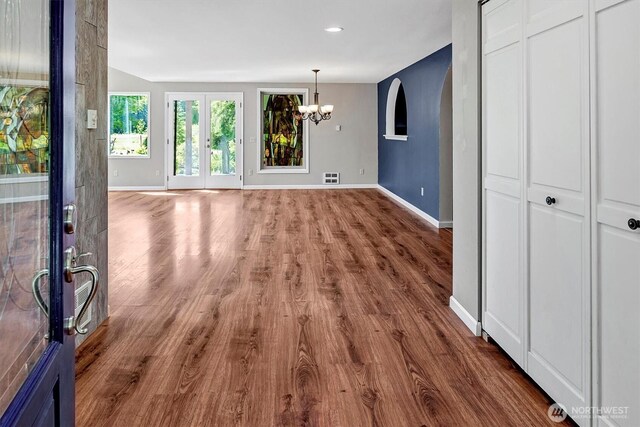 25321 133rd Ave NE, Arlington, WA 98223 - unfurnished living room with french doors, a chandelier, wood finished floors, and recessed lighting