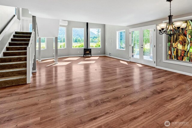 25321 133rd Ave NE, Arlington, WA 98223 - unfurnished living room with a wood stove, stairs, plenty of natural light, and wood finished floors