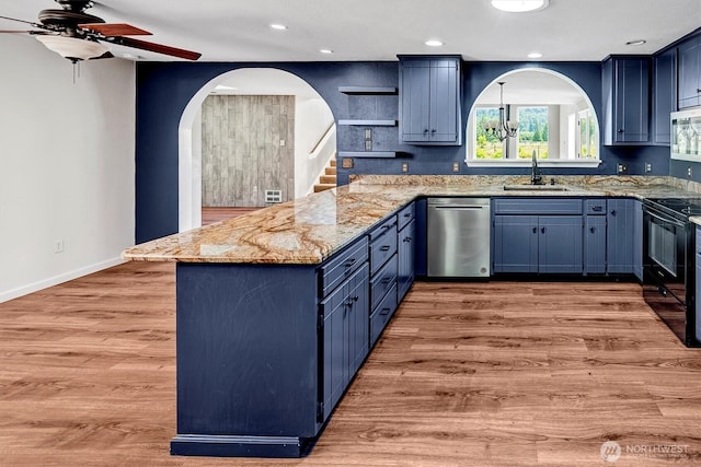 25321 133rd Ave NE, Arlington, WA 98223 - kitchen featuring appliances with stainless steel finishes, blue cabinetry, light stone countertops, a peninsula, and ceiling fan