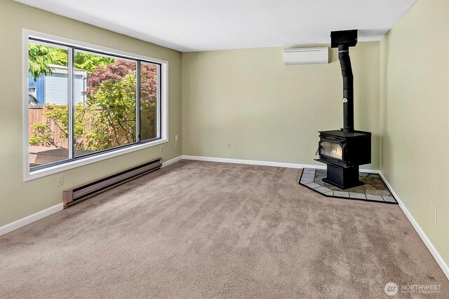 25321 133rd Ave NE, Arlington, WA 98223 - unfurnished living room featuring baseboard heating, carpet floors, a wood stove, and a wall unit AC