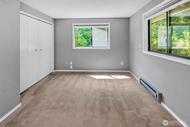 25321 133rd Ave NE, Arlington, WA 98223 - unfurnished bedroom with baseboard heating, multiple windows, carpet floors, and a closet