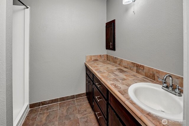 25321 133rd Ave NE, Arlington, WA 98223 - bathroom featuring vanity, a shower, and tile patterned flooring
