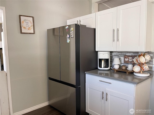 15410 SE 272nd St Unit 71, Kent, WA 98030 - kitchen featuring freestanding refrigerator, tasteful backsplash, white cabinets, and stainless steel countertops