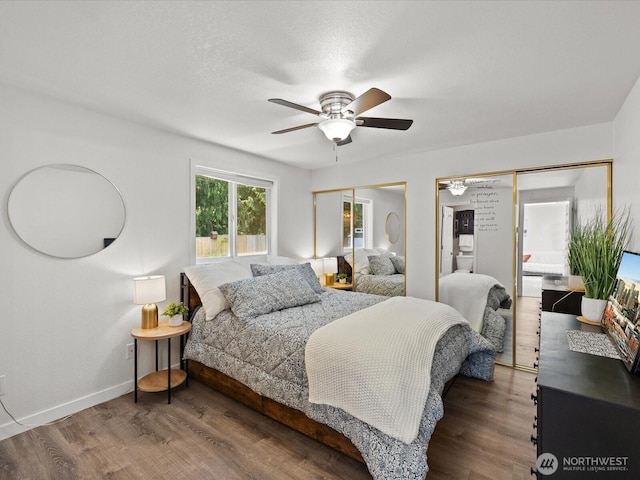 7102 Church Creek Cir NW, Stanwood, WA 98292 - bedroom featuring wood finished floors, a ceiling fan, and multiple closets