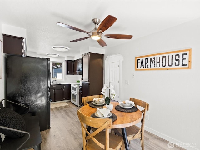 7102 Church Creek Cir NW, Stanwood, WA 98292 - dining space with ceiling fan and light wood-style flooring