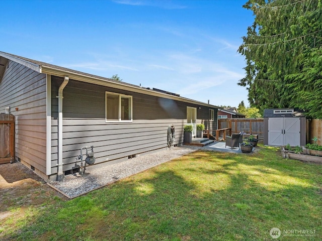 7102 Church Creek Cir NW, Stanwood, WA 98292 - rear view of house with a storage shed, crawl space, and a patio