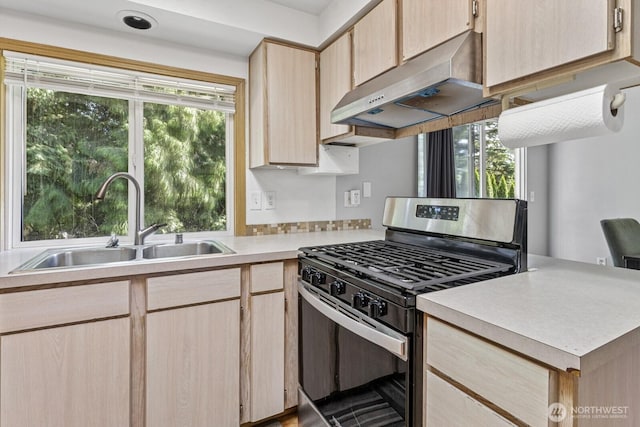 1717 14th Ave SE, Olympia, WA 98501 - kitchen with stainless steel gas stove, under cabinet range hood, light brown cabinets, and light countertops