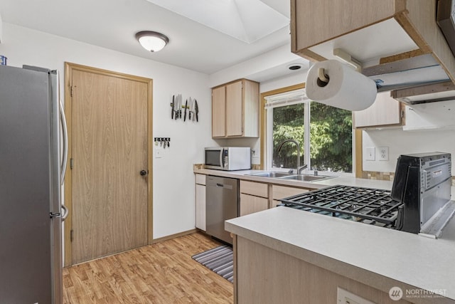 1717 14th Ave SE, Olympia, WA 98501 - kitchen featuring appliances with stainless steel finishes, light brown cabinetry, light wood-type flooring, and light countertops