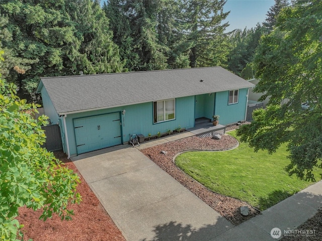 1717 14th Ave SE, Olympia, WA 98501 - single story home with a garage, concrete driveway, roof with shingles, and a front lawn
