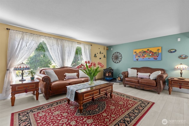 6830 SE Arlington Pl, Port Orchard, WA 98367 - living room featuring a wood stove and wood finished floors