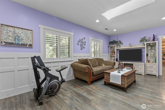 6830 SE Arlington Pl, Port Orchard, WA 98367 - living room featuring a skylight, a decorative wall, wood finished floors, a wainscoted wall, and recessed lighting