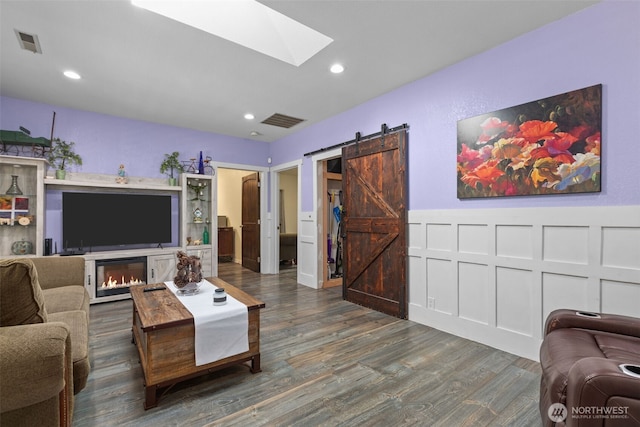 6830 SE Arlington Pl, Port Orchard, WA 98367 - living area featuring a skylight, wood finished floors, a barn door, and recessed lighting