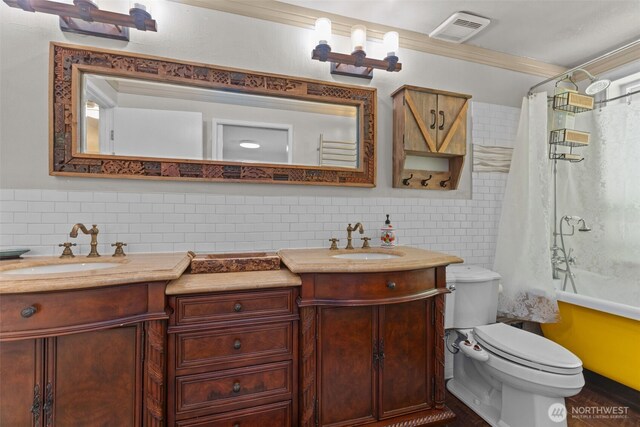 6830 SE Arlington Pl, Port Orchard, WA 98367 - full bath with double vanity, tile walls, ornamental molding, shower / bath combo, and a wainscoted wall
