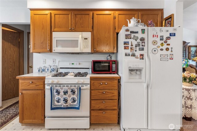 9923 74th Ave E, Puyallup, WA 98373 - kitchen featuring white appliances, light countertops, and brown cabinets