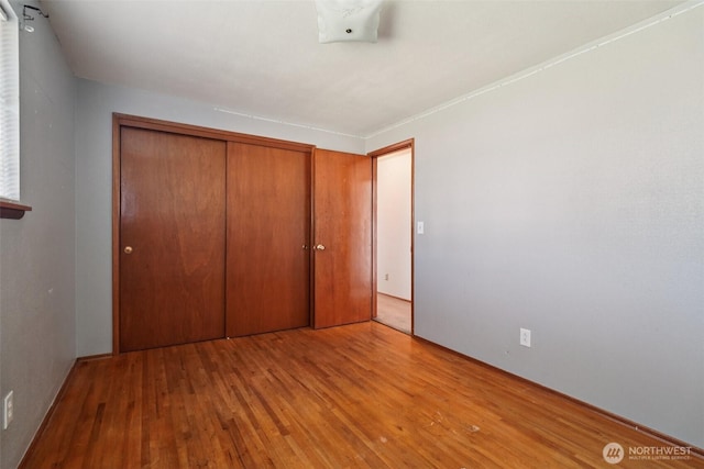 411 15th Ave, Milton, WA 98354 - unfurnished bedroom with wood finished floors and a closet