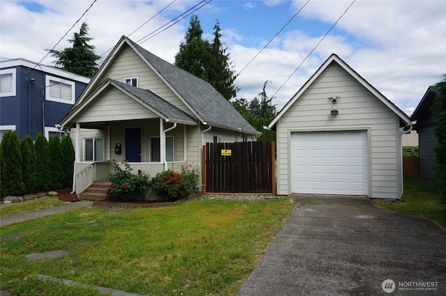 608 S 6th Ave, Kelso, WA 98626 - view of front of property featuring a porch, asphalt driveway, a garage, an outbuilding, and a shingled roof
