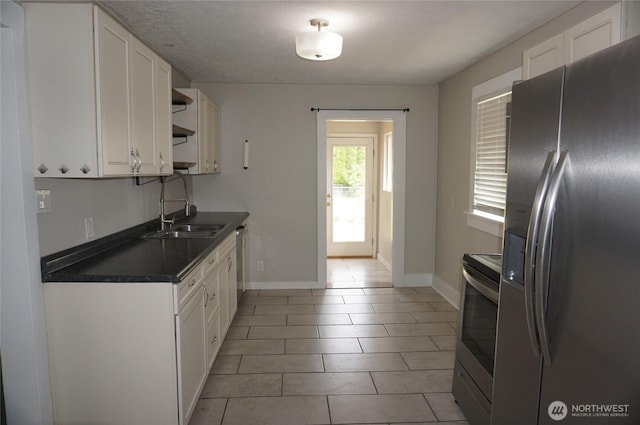 608 S 6th Ave, Kelso, WA 98626 - kitchen featuring stainless steel appliances, dark countertops, white cabinets, open shelves, and light tile patterned floors