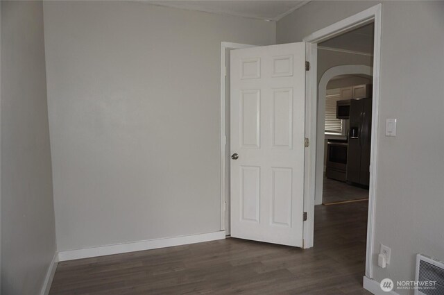 608 S 6th Ave, Kelso, WA 98626 - unfurnished room with arched walkways and dark wood finished floors