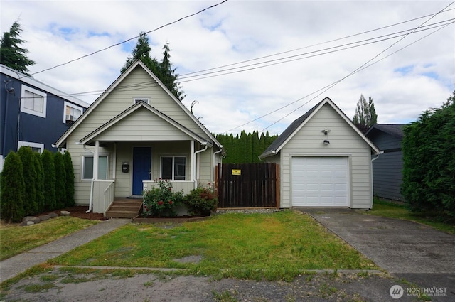 608 S 6th Ave, Kelso, WA 98626 - view of front of home featuring a detached garage, a porch, concrete driveway, and an outdoor structure