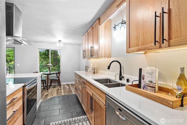 3104 Bill Mcdonald Pkwy Unit D104, Bellingham, WA 98225 - kitchen featuring stainless steel appliances, wall chimney exhaust hood, light countertops, and wood finished floors