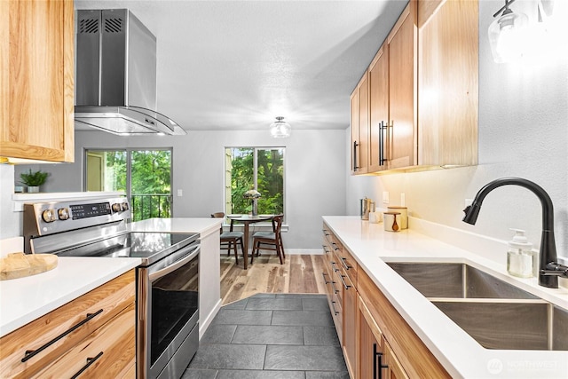 3104 Bill Mcdonald Pkwy Unit D104, Bellingham, WA 98225 - kitchen with stainless steel electric stove, wall chimney range hood, and light countertops