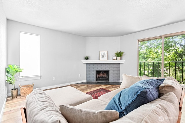 3104 Bill Mcdonald Pkwy Unit D104, Bellingham, WA 98225 - living area featuring wood finished floors, a fireplace, and a textured ceiling