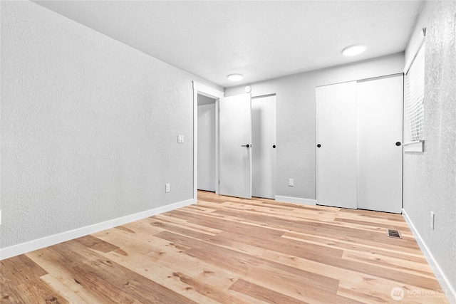 3104 Bill Mcdonald Pkwy Unit D104, Bellingham, WA 98225 - unfurnished bedroom featuring light wood-style floors and a textured wall