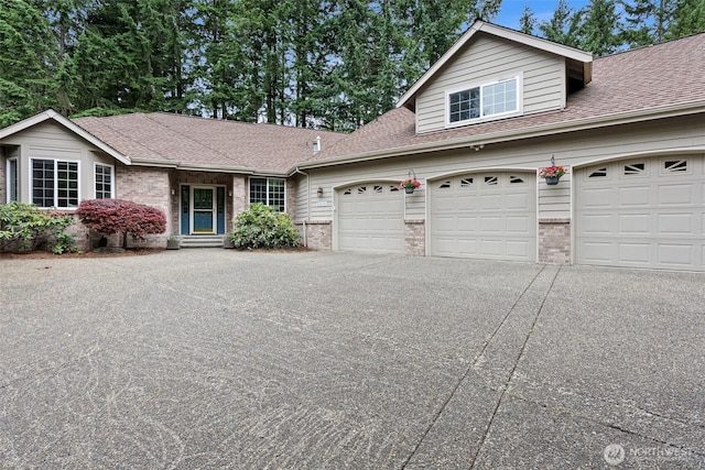 7506 Hawkstone Ave SW, Port Orchard, WA 98367 - traditional-style home featuring brick siding, driveway, roof with shingles, and a garage