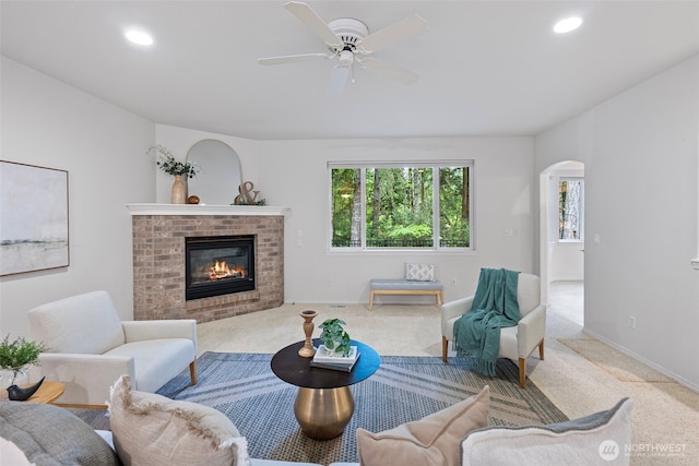 7506 Hawkstone Ave SW, Port Orchard, WA 98367 - living room with arched walkways, carpet floors, a fireplace, ceiling fan, and recessed lighting