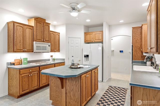 7506 Hawkstone Ave SW, Port Orchard, WA 98367 - kitchen featuring white appliances, ceiling fan, recessed lighting, arched walkways, and a center island