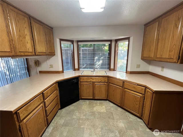 7908 53rd St W, University Place, WA 98467 - kitchen with dishwasher, brown cabinetry, light countertops, and a peninsula
