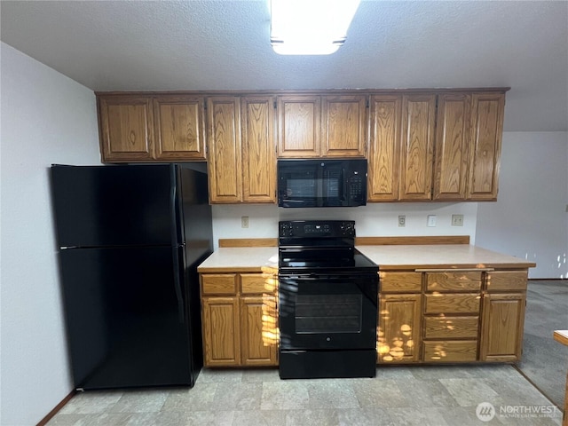 7908 53rd St W, University Place, WA 98467 - kitchen with black appliances, light countertops, and brown cabinets