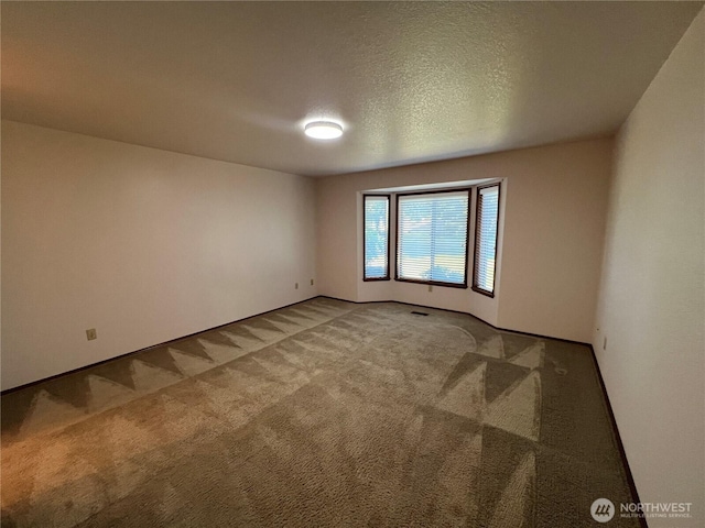 7908 53rd St W, University Place, WA 98467 - carpeted empty room featuring a textured ceiling and baseboards