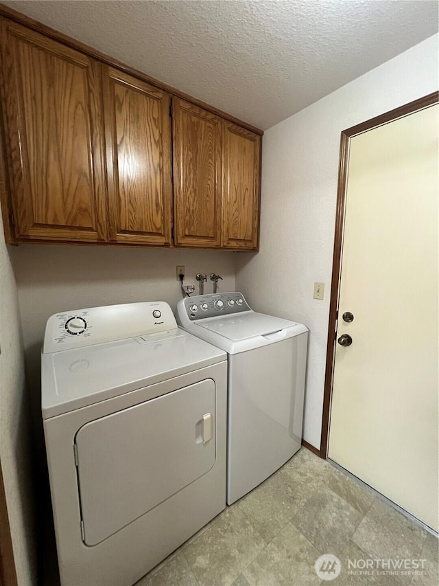 7908 53rd St W, University Place, WA 98467 - washroom featuring independent washer and dryer, cabinet space, and a textured ceiling