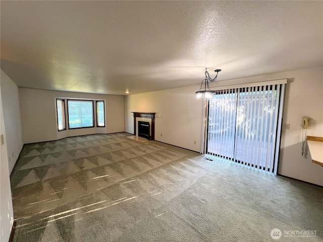 7908 53rd St W, University Place, WA 98467 - unfurnished living room with carpet, a textured ceiling, and a fireplace