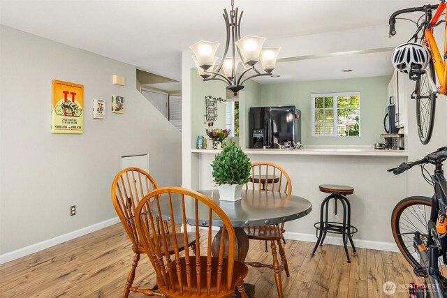 15600 116th Ave NE Unit E4, Bothell, WA 98011 - dining space featuring wood-type flooring and a chandelier