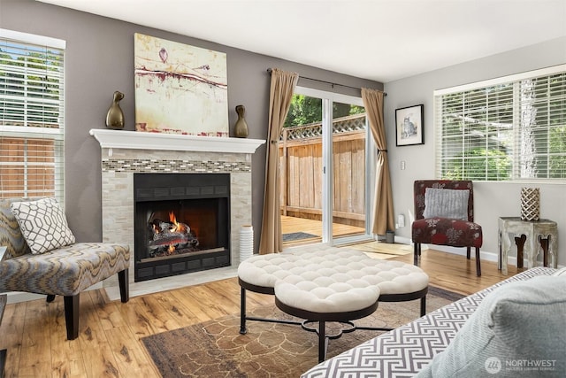 15600 116th Ave NE Unit E4, Bothell, WA 98011 - living room featuring wood finished floors, healthy amount of natural light, and a tiled fireplace