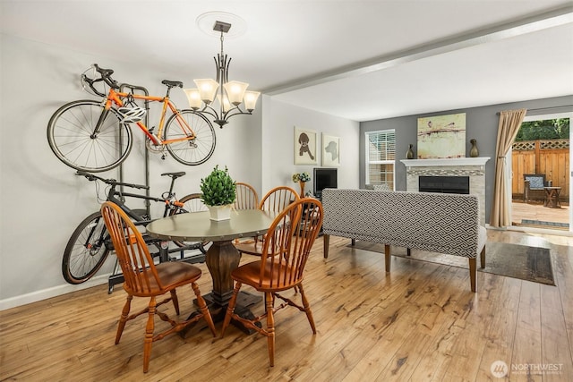 15600 116th Ave NE Unit E4, Bothell, WA 98011 - dining area featuring light wood-style flooring, a chandelier, and a tile fireplace