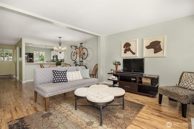 15600 116th Ave NE Unit E4, Bothell, WA 98011 - living room with light wood-style floors, a chandelier, and a baseboard radiator