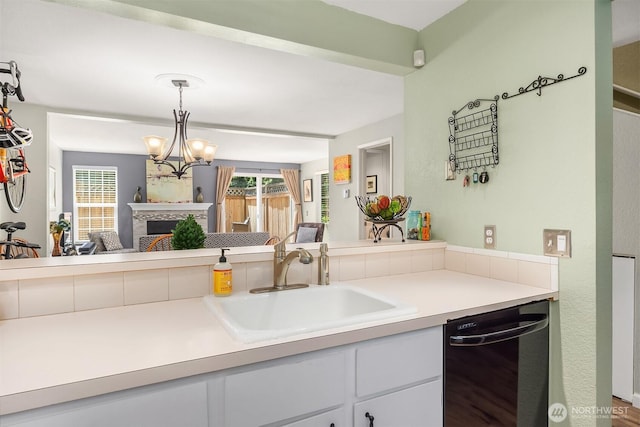 15600 116th Ave NE Unit E4, Bothell, WA 98011 - kitchen featuring dishwasher, a tiled fireplace, light countertops, decorative light fixtures, and open floor plan