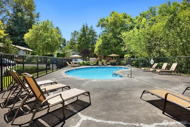15600 116th Ave NE Unit E4, Bothell, WA 98011 - community pool with a patio area and view of scattered trees