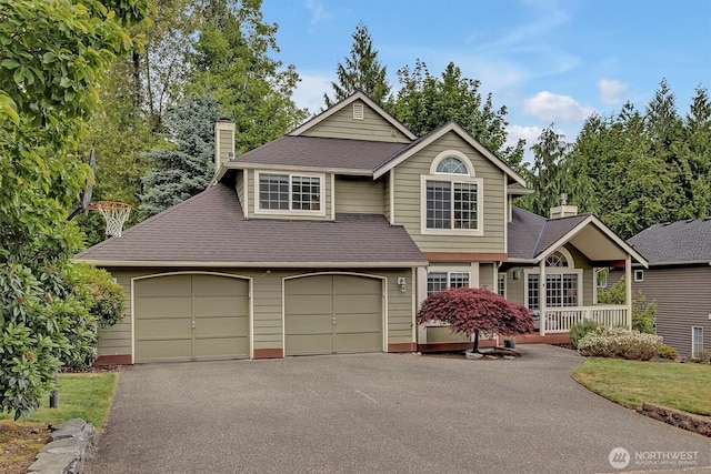1125 Hemlock Ave SW, North Bend, WA 98045 - view of front facade featuring asphalt driveway, a chimney, and roof with shingles