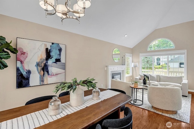 1125 Hemlock Ave SW, North Bend, WA 98045 - dining room with wood finished floors, a chandelier, a premium fireplace, and high vaulted ceiling